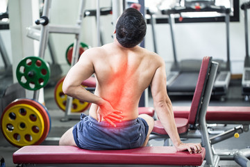 man with back injury at gym