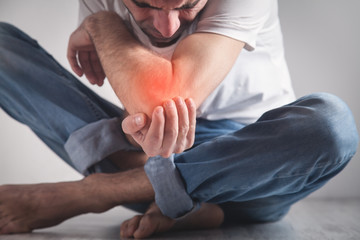 man with chronic elbow pain