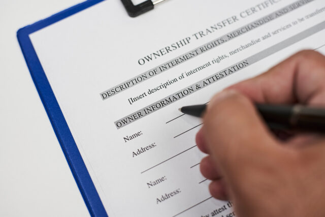 A person filling ownership transfer certificate document
