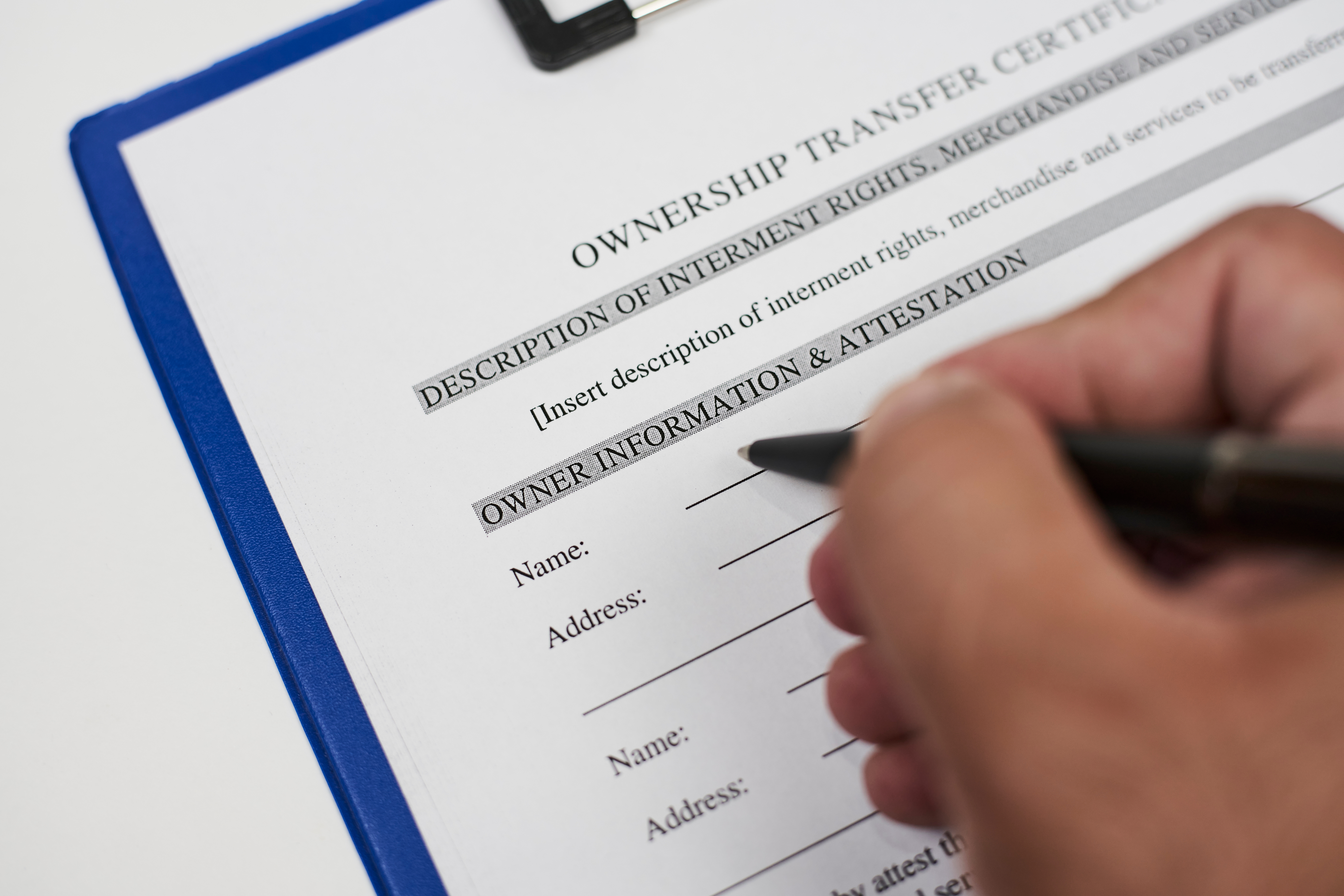 A person filling ownership transfer certificate document